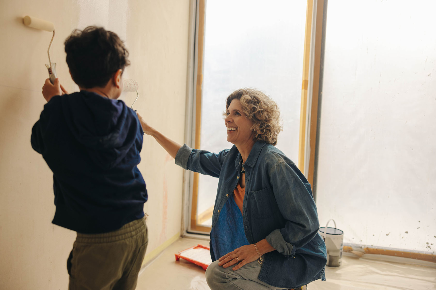 Adult and child painting a room together, illustrating how clear, dependable tax preparation helps families stay focused on everyday moments.