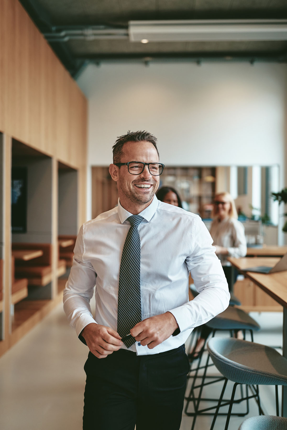 Smiling professional walking through a modern office, reflecting confidence supported by accurate tax documentation and trustworthy accountancy services.