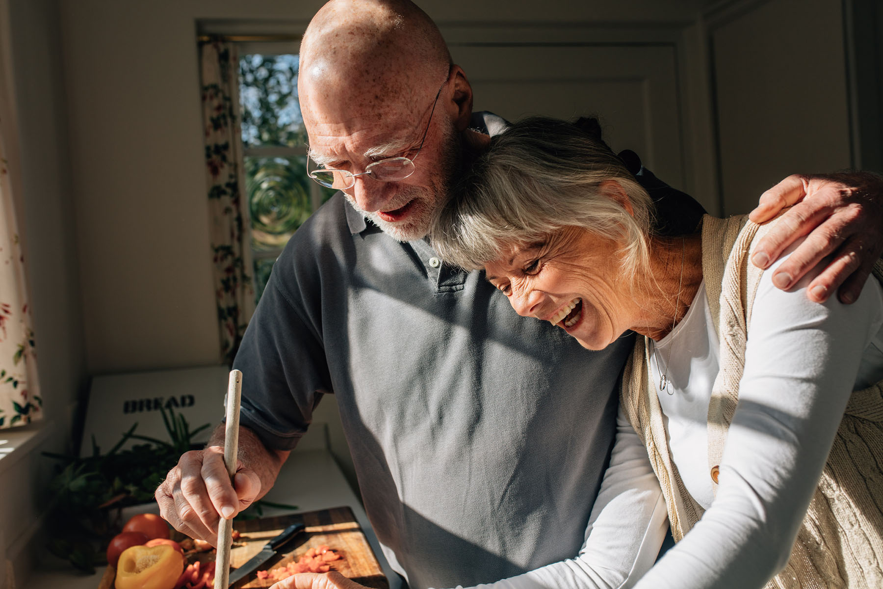 Older couple cooking together in a bright kitchen, reflecting the comfort and clarity supported by dependable tax preparation and trusted accountancy services.